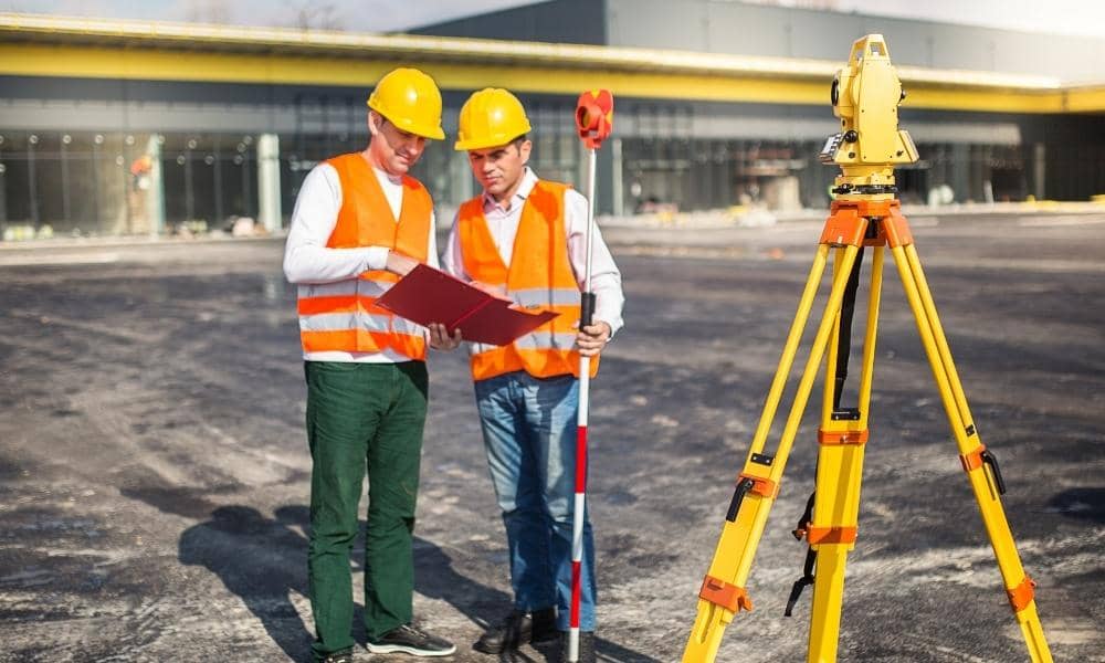 Surveyors conducting an ALTA survey at a commercial property before a real estate transaction