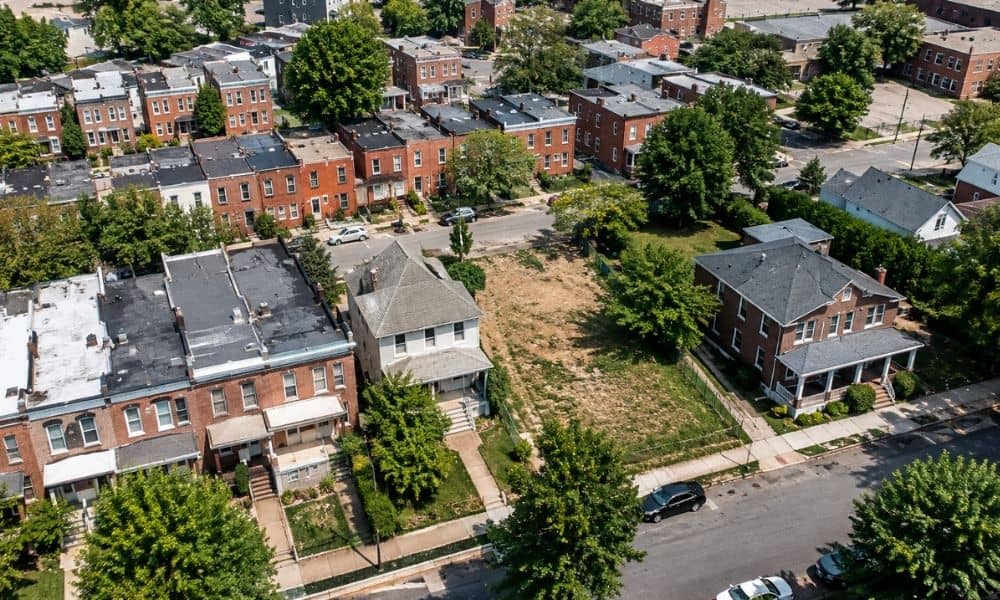 Aerial view of a Baltimore residential neighborhood with homes, streets, and a vacant parcel relevant to a loan closing survey