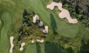 Aerial view of a golf course with fairways, greens, bunkers, and wooded areas that can be mapped through drone surveying for renovation planning